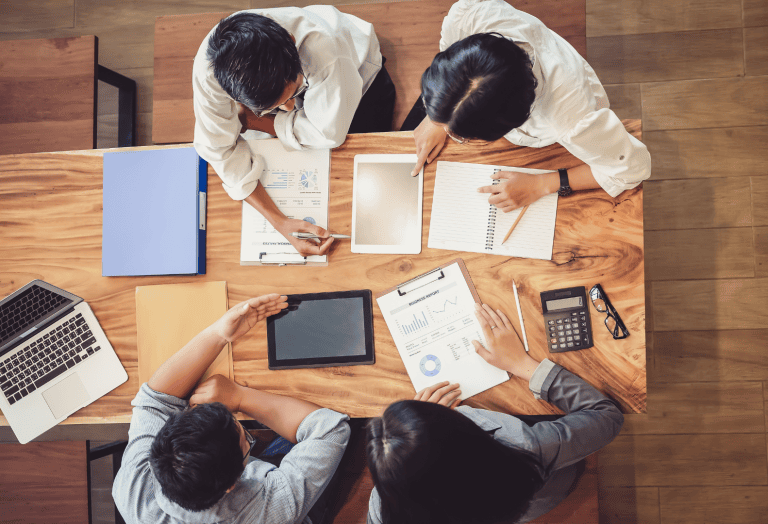 ISO 56001 innovation management system: a leadership team reviews reports, objectives and results around a table