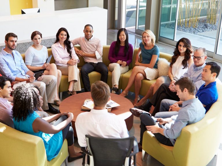 Innovation management framework that starts with people: a team seated in a circle, discussing ideas